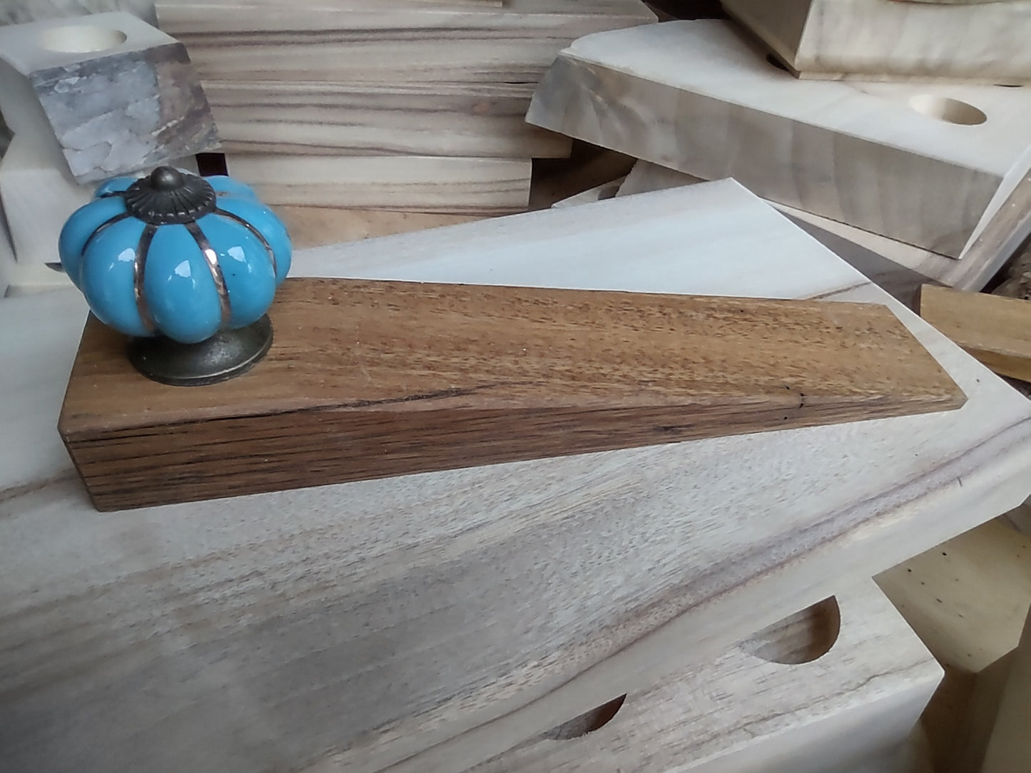 Door stop - Light blue knob on blonde timber.