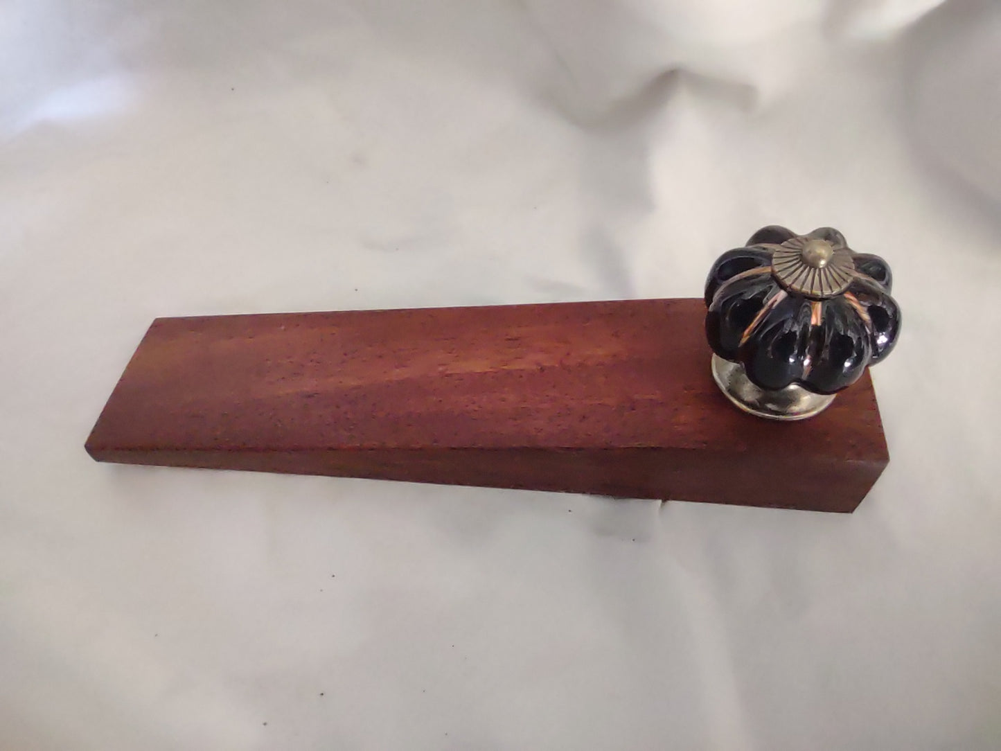 Door stop. Black knob with Gold flutes - Brown timber.