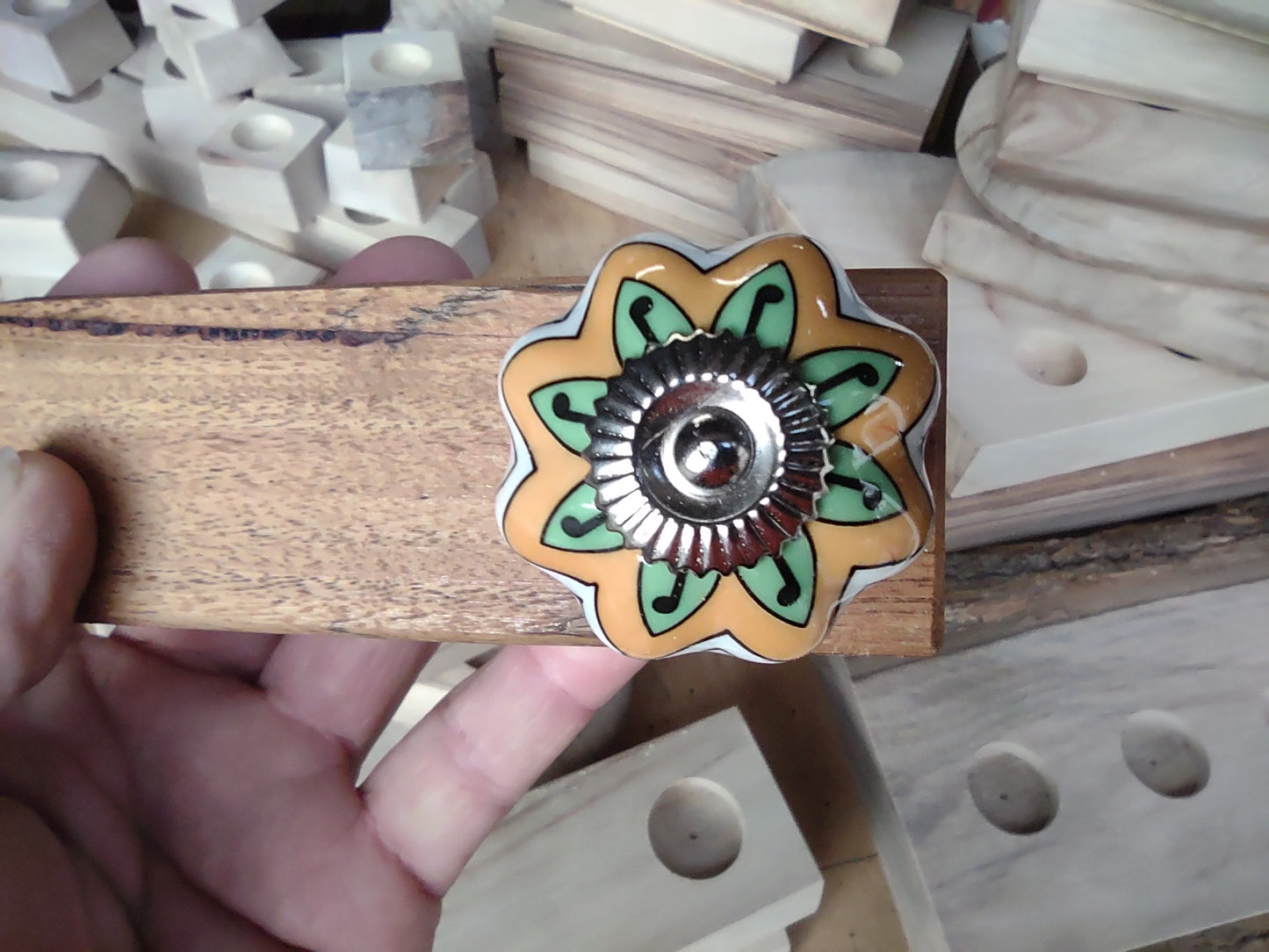 Door stop, White/Orange/Green knob on blonde timber.