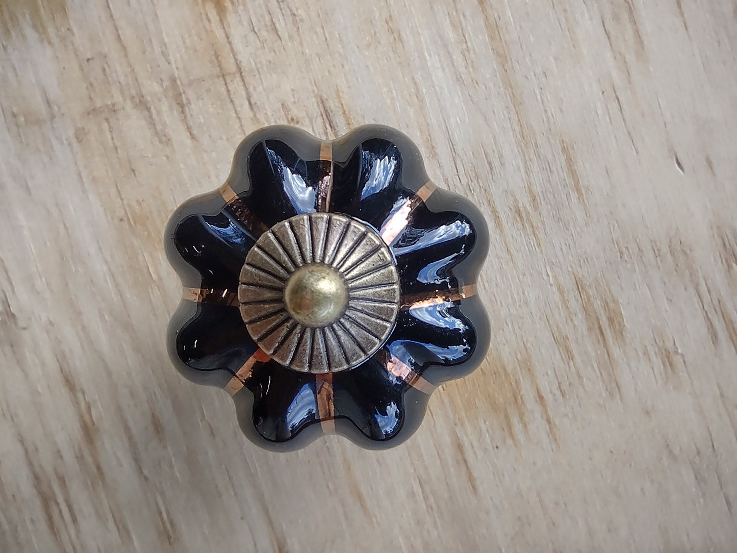 Door stop. Black knob with Gold flutes - Brown timber.