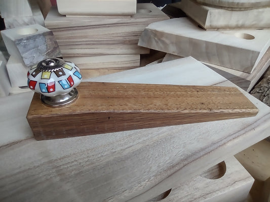 Door stop, White knob with Yellow/Brown & Red/Blue pattern on blonde timber.