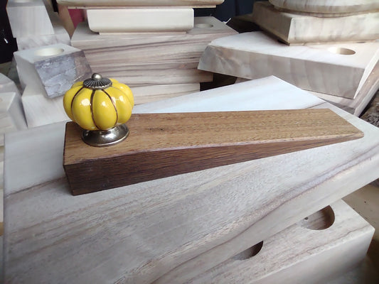 Door stop - Yellow knob on blonde timber.